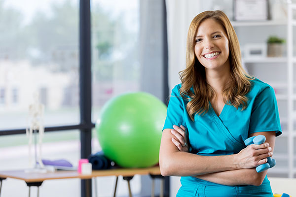 physical therapist smiles in office