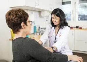 Phlebotomist Smiling Near Patient Phlebotomist Smiling Near Patient